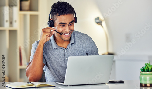 Call center telemarketing agent with headset and laptop working, assisting or talking to online web user. Male sales representative advisor with excellent customer service skills and business advice