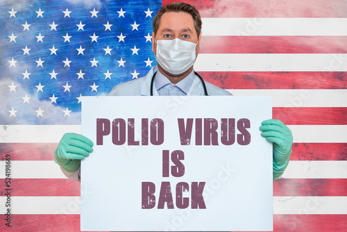 Inscription POLIO VIRUS IS BACK.Doctor holds mockup.detection of poliomyelitis virus.New polio virus infects dozens in USA.US flag background.