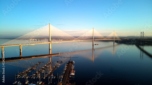 Aerial drone sunrise view of The Queensferry Crossing bridges over the Firth of Forth, Edinburgh, Scotland, UK.
