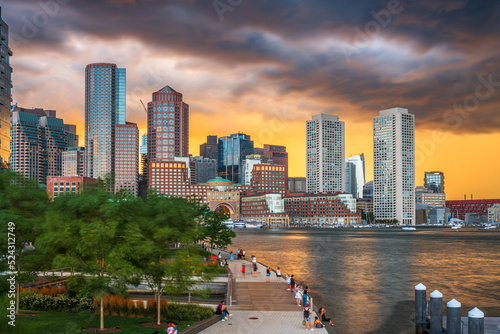 Boston, Massachusetts, USA downtown city skyline and pier at dusk.