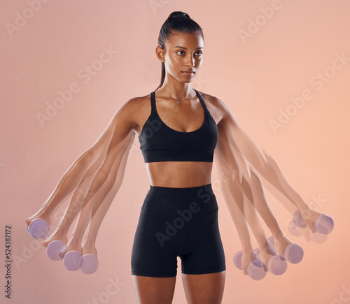 Fitness, workout and training female athlete lifting weights or dumbbells in a studio to stay healthy, active and strong. Wellness, cgi and young woman doing a side lateral raise exercises, portrait