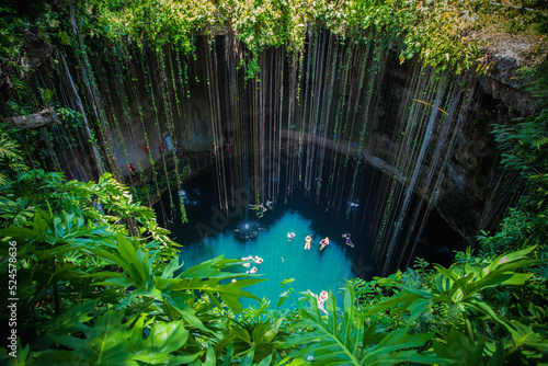 Ik-Kil Cenote, Mexico. Lovely cenote in Yucatan Peninsulla with transparent waters and hanging roots. Chichen Itza, Central America.