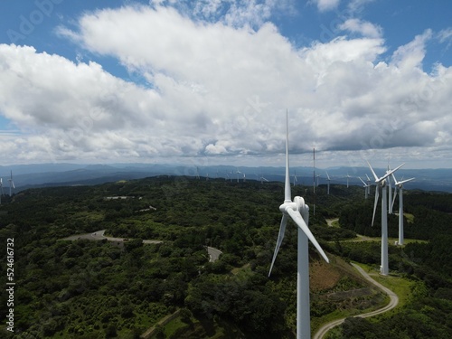 青空の青山高原の風車群をドローンで間近で空撮した写真