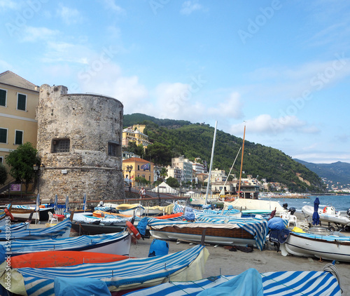 Fishing boats in sunny day on the beach of Laigueglia, Savona, Liguria, Ligurian Sea, Italy.