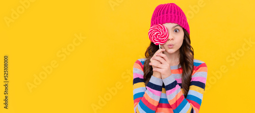 surprised teen girl hold lollipop. lollipop lady. hipster kid with colorful lollypop sugar candy. Teenager child with sweets, poster banner header, copy space.