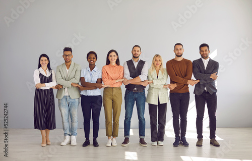 Portrait of diverse multiracial employees hold hands show team unity and integrity in office. Smiling multiethnic people feel united at workplace, involved in teambuilding. Business, teamwork.