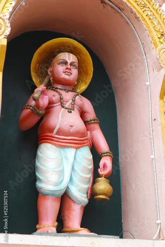 Vamanadeva or Vamana is the incarnation of Vishnu - a dwarf brahmin boy. Avatar of an Indian god on the wall of a Hindu temple.