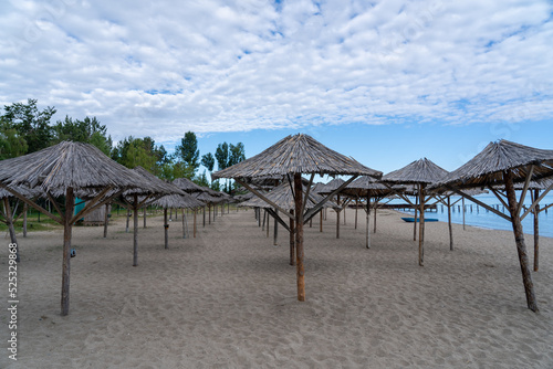 Clean beach with straw umbrellas