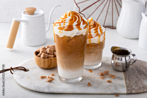 Iced caramel latte topped with whipped cream and caramel sauce