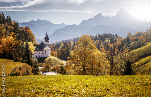 Beautiful nature landscape. Incredible autumn scenery. View on Alpine highlands with Watzmann mount, colorful trees and Small church. Famous Maria Gern Church. Berchtesgaden Bavaria Alps Germany