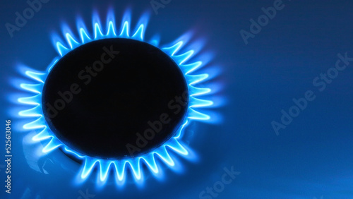 top view of burner with lit natural gas with space for text on blue background