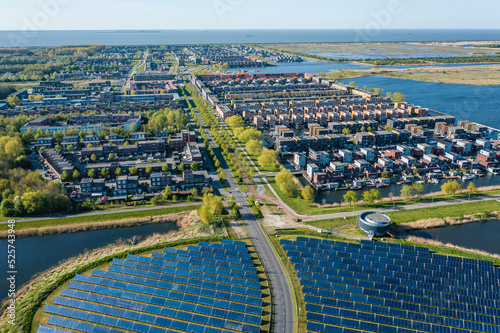 Modern sustainable neighbourhood in Almere, The Netherlands. The city heating (stadswarmte) in the district is partially powered by a solar panel island (Zoneiland). Aerial view.