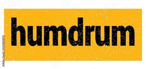 humdrum text written on yellow-black stamp sign.