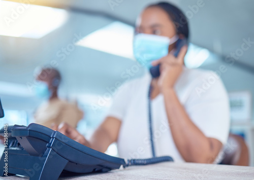 Business woman or receptionist on phone call with a mask for covid, corona or virus safety. Company office worker in startup workplace consulting or communication with client about telemarketing sale