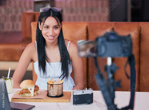 Food influencer, internet speaker at restaurant with camera and recording cooking review social media video. Digital cuisine web content creator or brand ambassador live streaming to online audience.