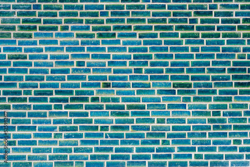 Background from a wall made of turquoise clinker bricks