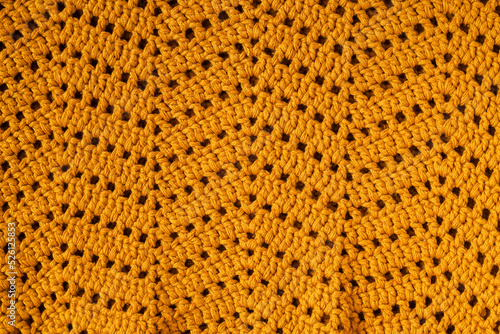 Yellow crochet texture with chevron stitch. Crochet fabric with zigzag pattern.