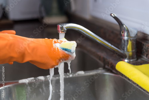 gloved hand, washing dishes