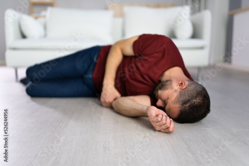 Unconscious Young Man Lying On Floor