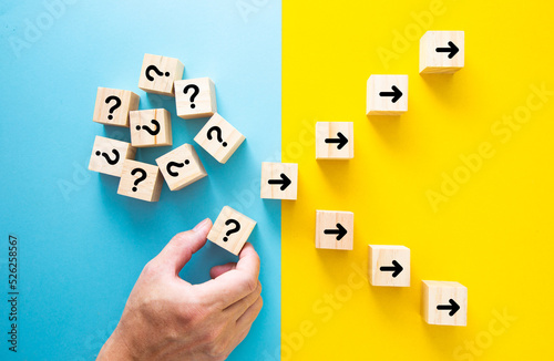 Hand choosing a block with question mark. ath leads to successful decision.