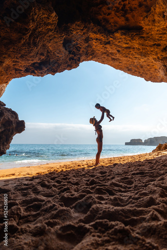 Having fun with the son in the beach cave in the Algarve, Praia da Coelha, Albufeira. Portugal
