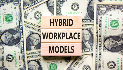 Hybrid workplace models symbol. Concept words Hybrid workplace models on wooden blocks on dollar bills. Beautiful background from dollar bills. Business hybrid workplace models concept. Copy space