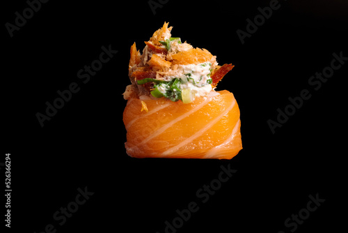 brazilian japanese food isolated on black background salmon and tuna sushi.