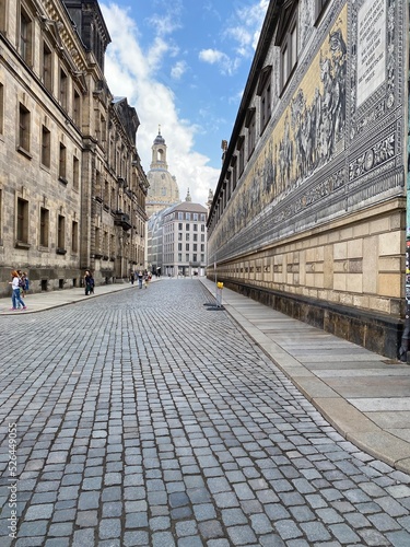 Public street view of the largest porcelain artwork in the world Furstenzug - Procession of Princess in Dresden, Germany, mural of a mounted procession of Saxony rulers