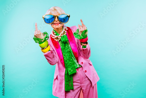 Cool and stylish senior old woman with fashionable clothes - Colorful portrait of funny happy elderly lady on colored background