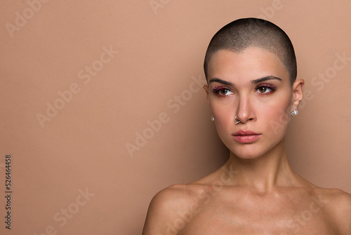 Beautiful woman with short shaved hair portrait on colored background, concept about beauty and skin care