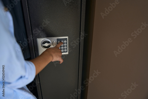 Boy presses the buttons on the gun safe