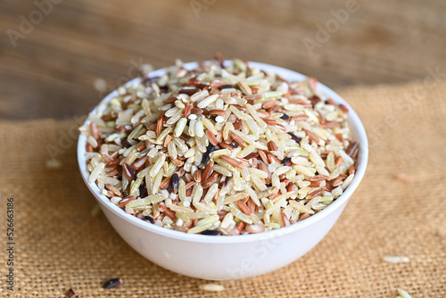 brown rice on white bowl, raw various rice color mixed thai rice for cooking food , Loonzain rice brown black red white purple health food