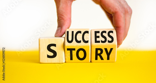 Success story symbol. Concept words Success story on wooden cubes. Businessman hand. Beautiful yellow table white background. Business and Success story concept. Copy space.