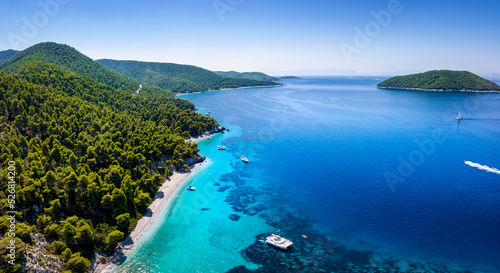 Aerial view of the beautiful coast of Skopelos island with turquoise sea at pristine beaches and thick pine forest, Sporades, Greece