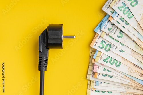 Electric plug and euro money. Concept of the increasing electricity prices.