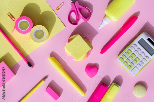 Yellow-pink school and office supplies on a yellow-pink background