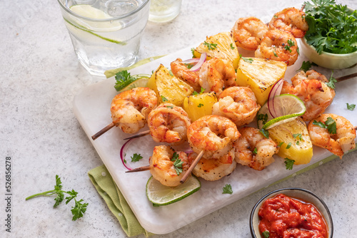 kebab skewers of barbecued shrimp with a pineapple