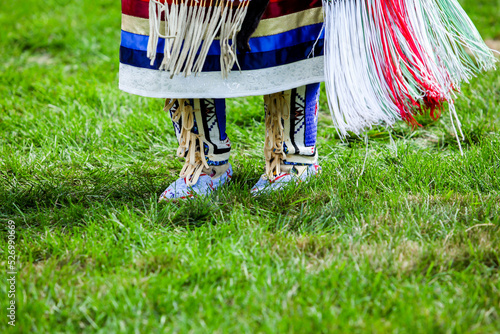 Close up from native American dancer moccasins on grass