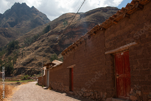 Adobe houses and wooden doors in Pisac, overlooking the mountains, Peru. 