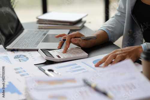 Business woman accountant working in office checking financial accounts and allocating company budgets.