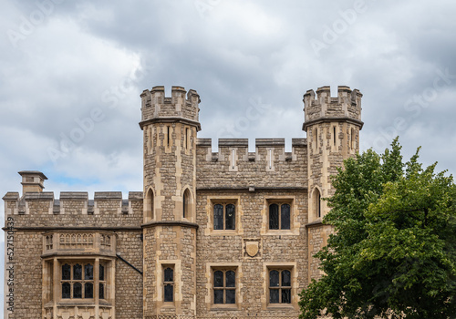 London, England, UK - July 6, 2022: Tower of London. Brown stone part of Fusilier Museum facade featuring coat of arms, lookout towers and windows.