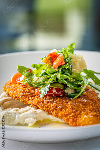 Chicken Milanese topped with Arugula, Oven Dried Tomato and Parmigiano Reggiano over Whipped Ricotta