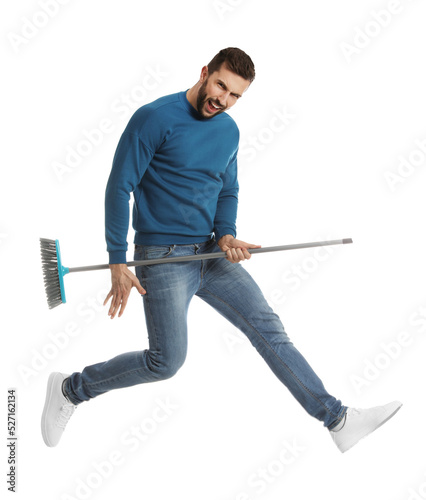 Man with broom jumping on white background