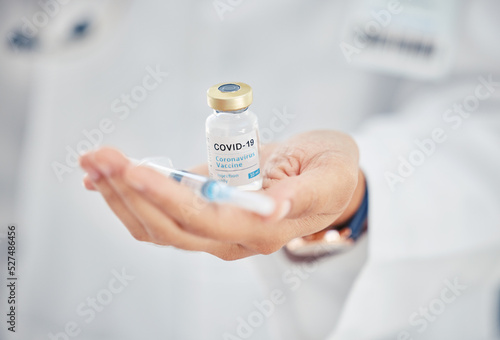 Covid vaccine vial, doctor hands and medicine injection for healthcare cure, wellness safety and antiviral booster shot in hospital clinic. Closeup of corona virus medical treatment immunity support