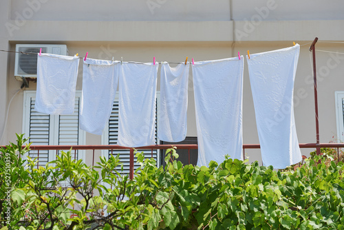 White towels drying on a sunny day