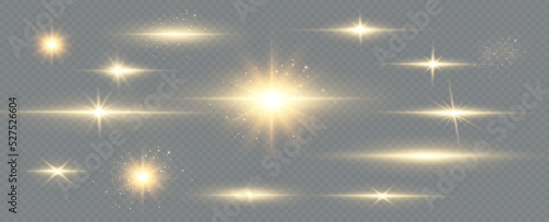 Golden particles of light. Golden light. Light flare.Stars isolated on transparent background.