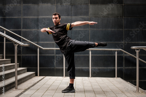 Young male dancer performing in an urban environment.