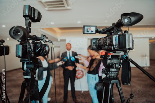 professional video production camera recording live event on stage. television social media broadcasting seminar conference.