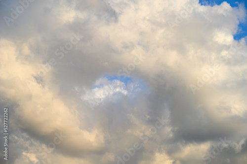 Dramatic cloudscape on a sunny day, blue sky and white clouds as a nature background 