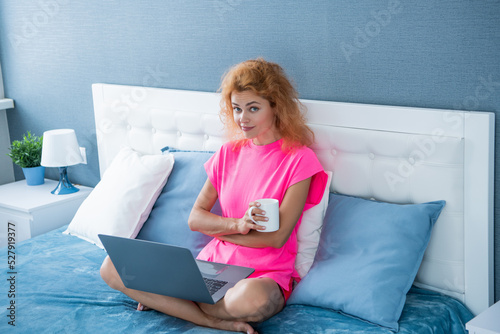 sceptic woman freelancer with coffee work at home on laptop. freelancer woman work at home.